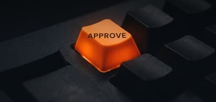 Glowing approve key on a dark keyboard